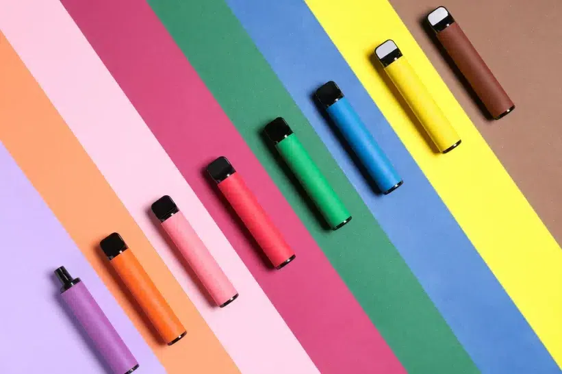 a group of colorful CBD vapes on a table