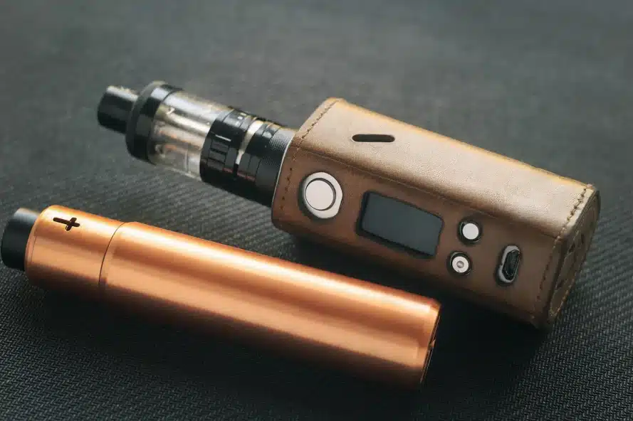 Two high end vape devices on a surface