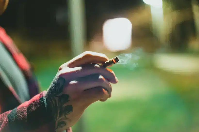 Person holding a smoking pre-roll