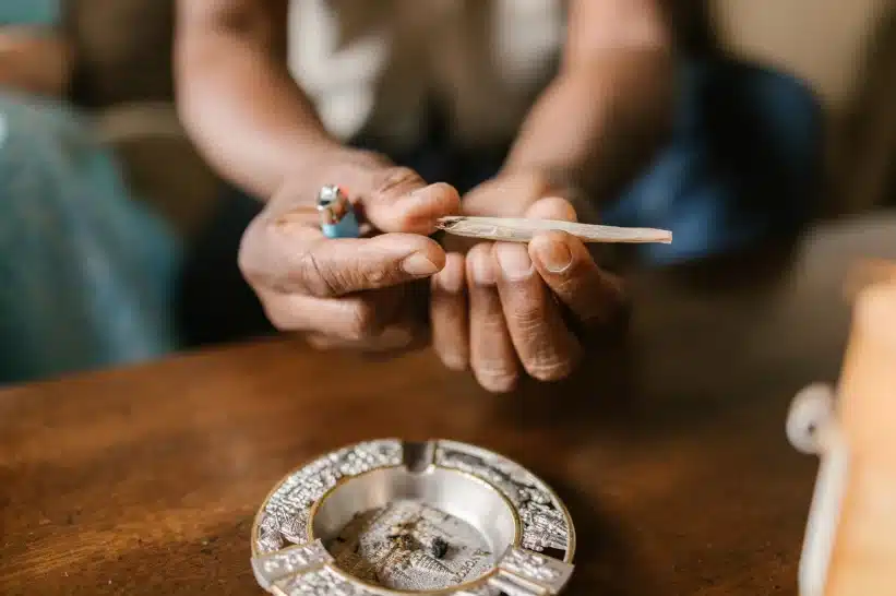 Person holding a rolled joint