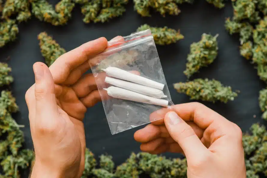 Hands holding bag of pre-rolls