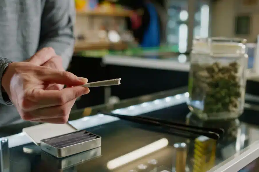 Person holding a pre-rolled joint