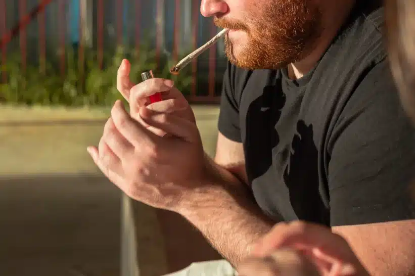 Man smoking with lighter in hand